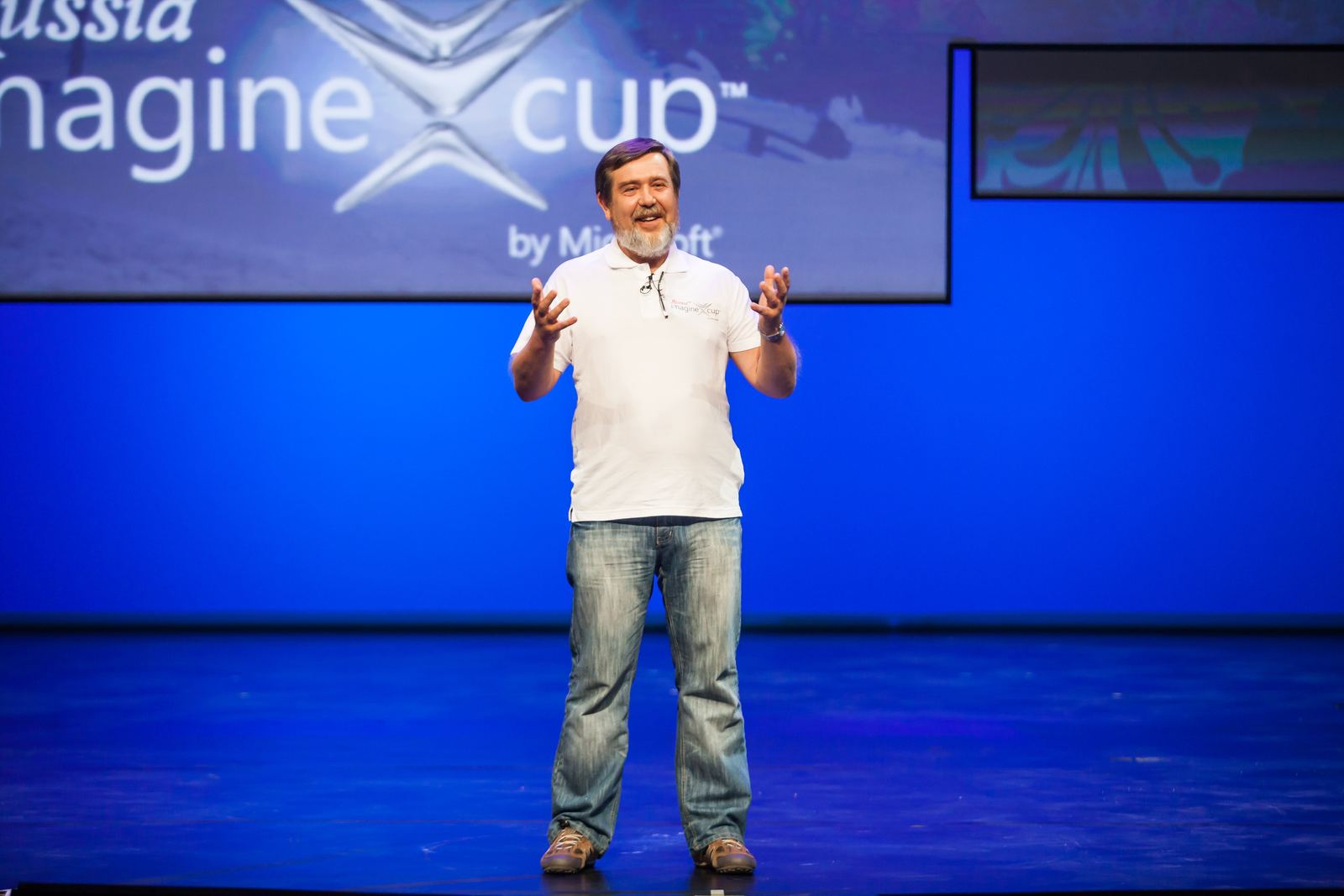 Tetris creator Alexey Pajitnov speaking on a blue-lit stage at the Imagine Cup in 2013