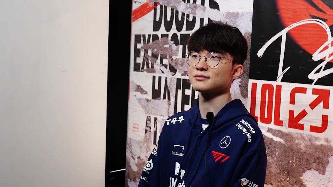 T1 player Faker in a dark team jacket standing in front of a graffiti-style backdrop at the 2023 Mid-Season Invitational